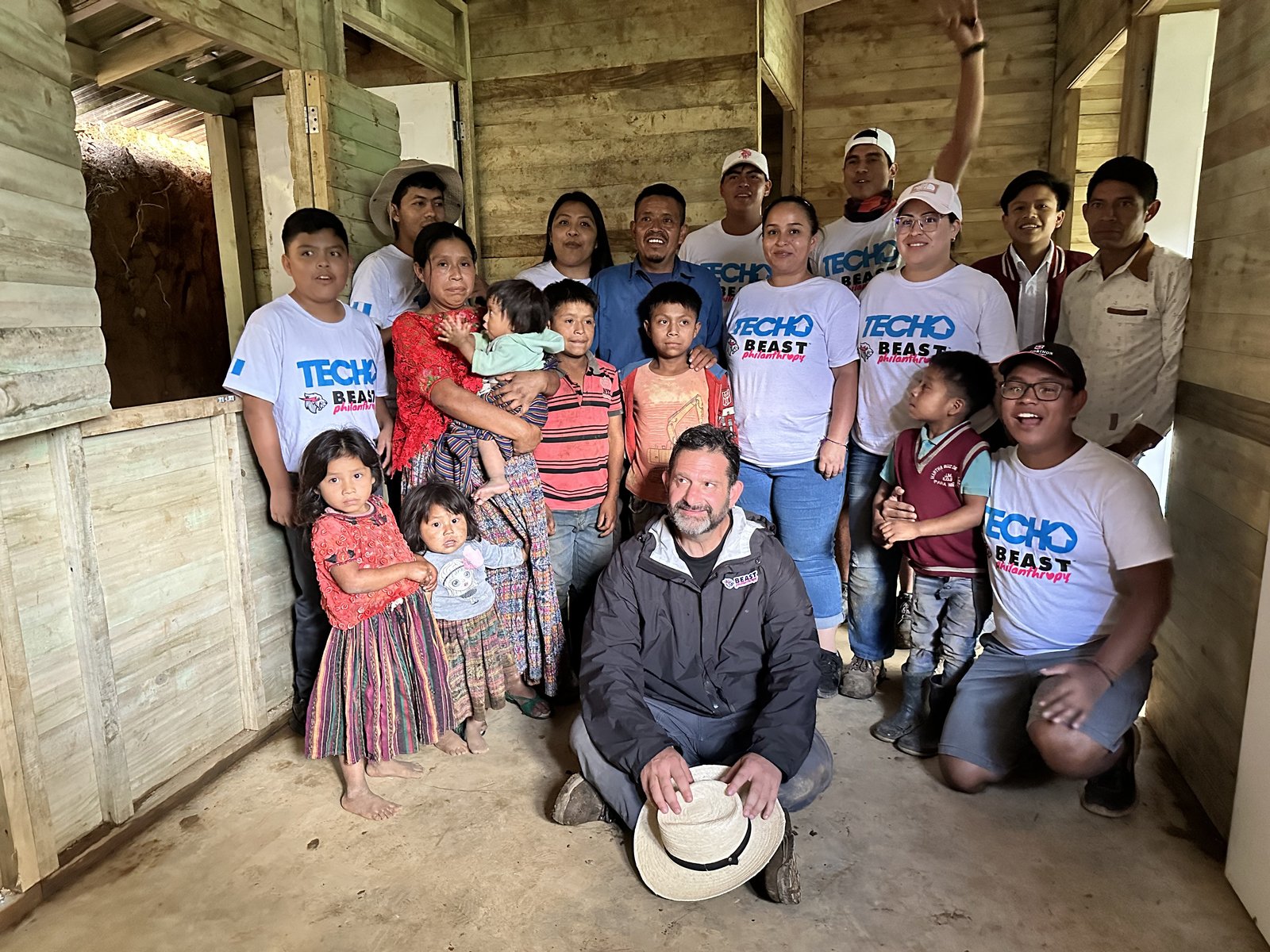 Darren Margolias with TECHO and Beast Philanthropy volunteers and a Guatemalan family inside a newly built home
